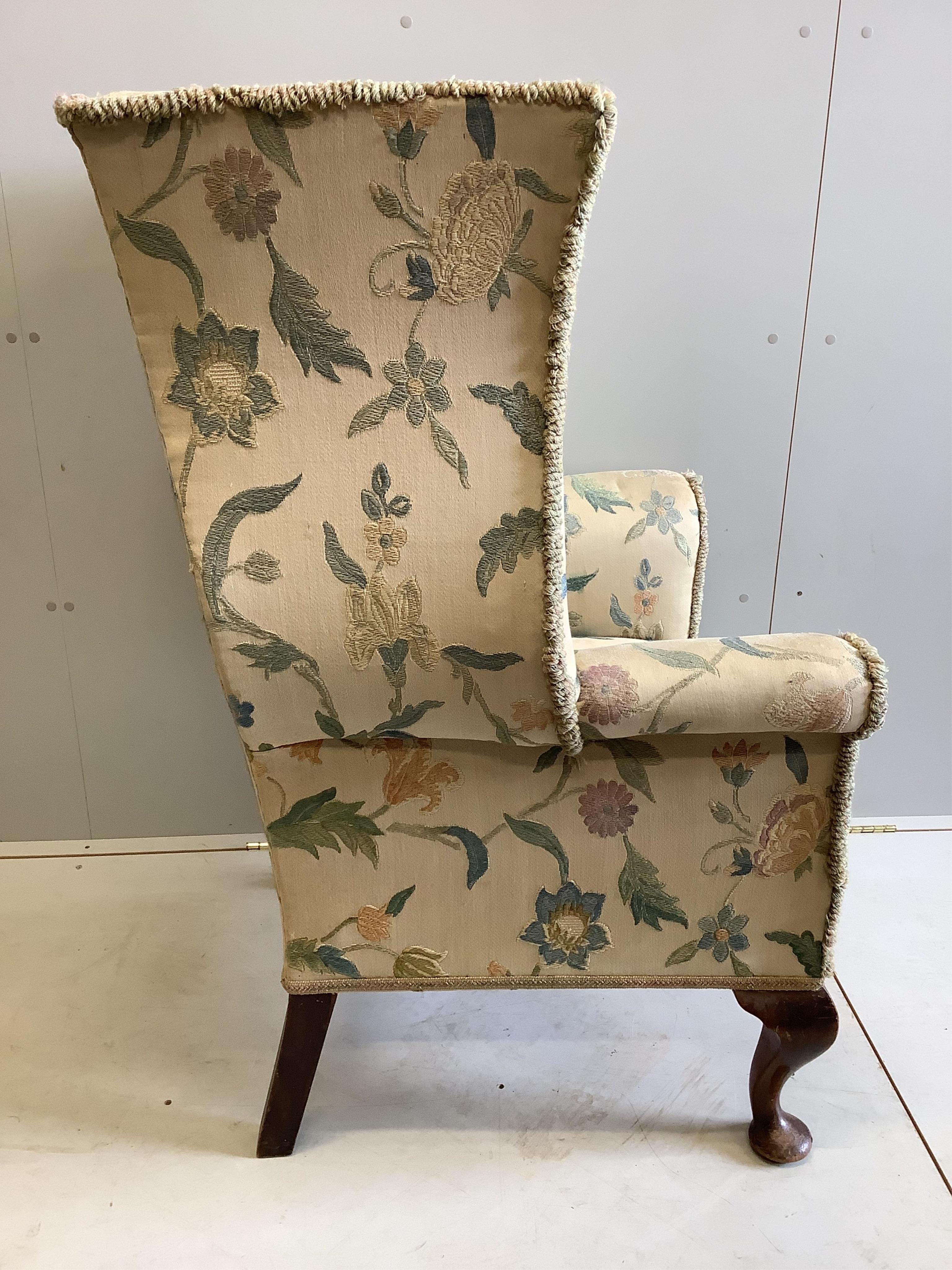A George I style upholstered wing back armchair, width 79cm, depth 70cm, height 120cm. Condition - fair